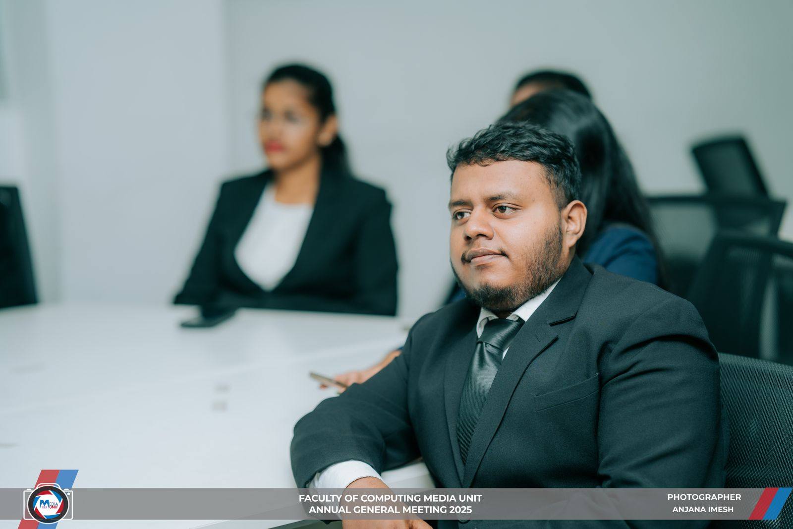 Aweesha Wijesundara in a dark suit seated at a meeting table during the SLIIT FCMU annual general meeting 2025