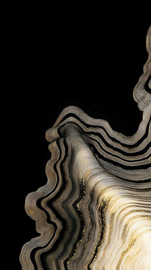 Abstract gold waves swirl over a deep black background, forming fluid metallic lines like marble texture.