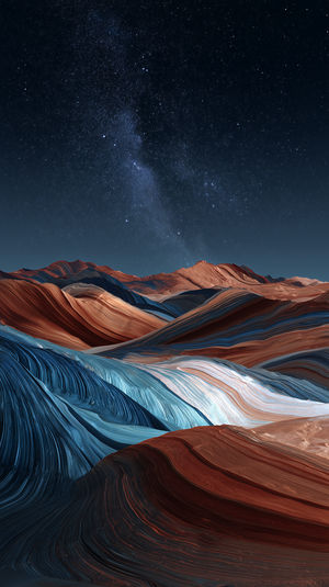 Swirling red and blue sandstone waves in an abstract desert landscape under a starlit night sky.
