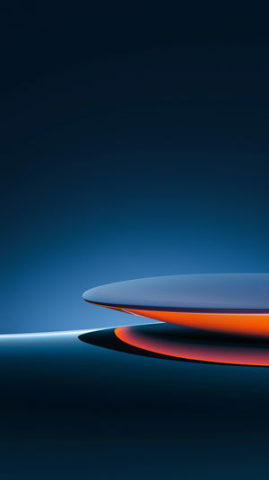 Glowing blue and orange abstract discs floating above a dark gradient background, creating a minimalist futuristic scene.