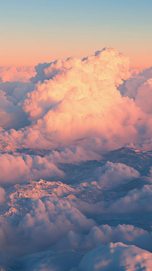 High-resolution pastel cloudscape with sunlit pink and blue clouds stretching across a tranquil sky view