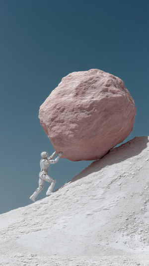 A futuristic white robot pushing a giant pinkish boulder uphill on a minimalistic white slope under a clear blue sky.