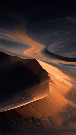 Aerial minimalist sand dune centered on a golden background with sculpted ridges and deep shadows ultra HD image