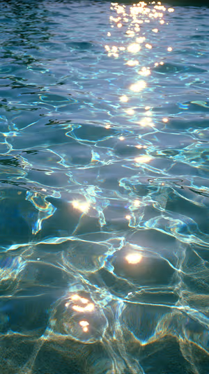 Shimmering aqua ripples with sun glint reflections on a turquoise surface in a minimalist aesthetic, ultra HD