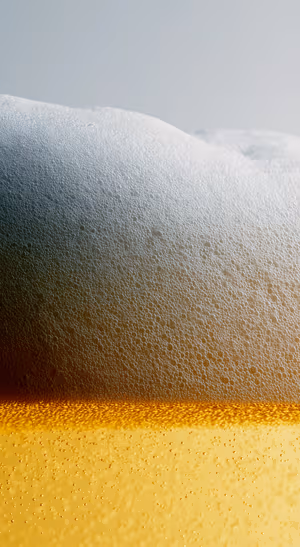 Golden Foam Macro — iPhone lock screen wallpaper