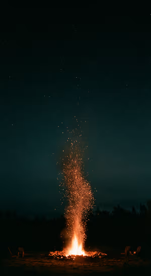 Cinematic campfire centered on a dark teal background in a cinematic aesthetic.