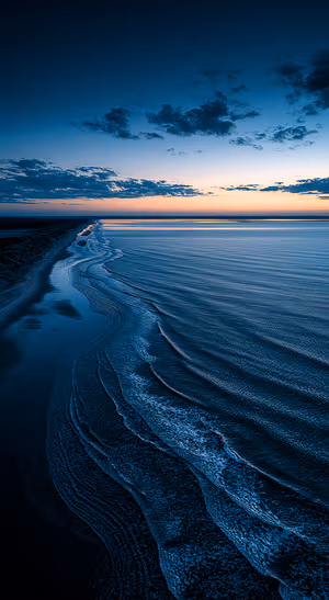 Aerial minimalist coastline centered on a deep blue background with moody dusk tones, ultra HD 8K image.