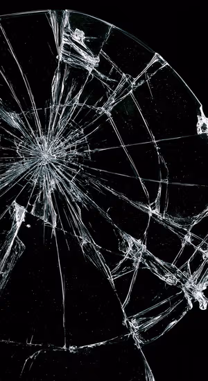 Abstract cracked glass with bright white fractures on a deep black background in a dark aesthetic
