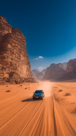 Cinematic desert SUV driving between towering sandstone cliffs on orange sand with deep blue sky ultra hd 8K mobile background.
