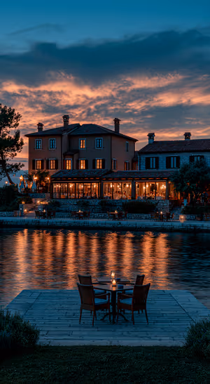 Cinematic lakeside villa at dusk with blue clouds and warm amber lights in an atmospheric aesthetic.