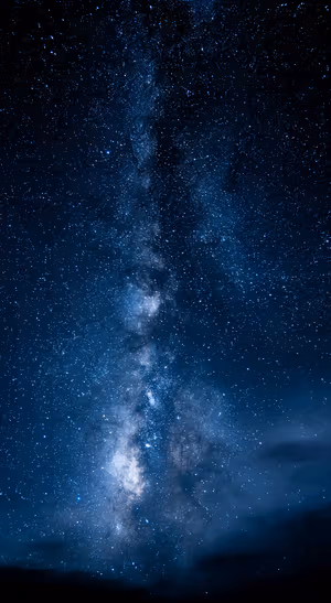Astrophotography Milky Way centered on a deep blue background in celestial aesthetic.