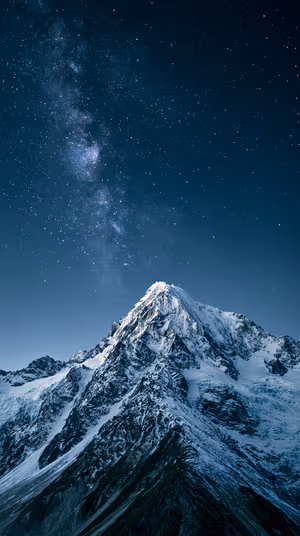 Astrophotography mountain peak beneath a deep blue starry sky, ultra hd 8K lock screen background.