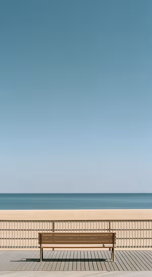 Minimalist ocean bench centered on a blue and beige background in minimalist aesthetic.