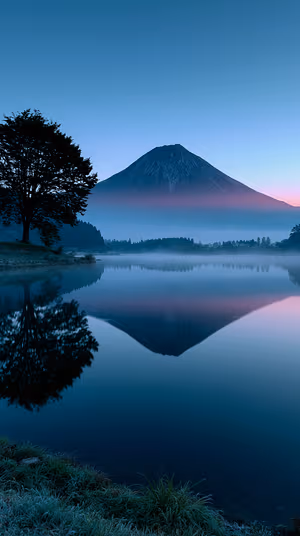 Minimalist mountain reflection on a blue to pink dawn background in a serene landscape aesthetic ultra HD 8K