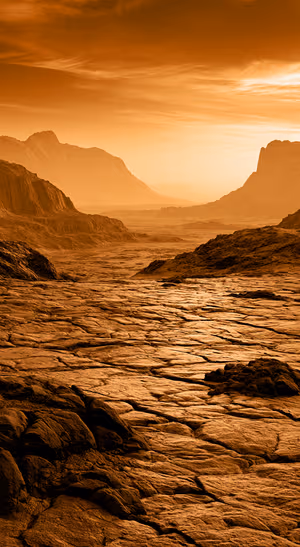 Cinematic mountain valley in amber tones with rugged rock textures beneath a glowing sky.