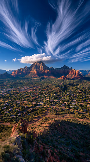 Dramatic Sedona red rock landscape with sweeping cirrus clouds and a lenticular cloud cap under a deep blue sky 8K ultra hd mobile background