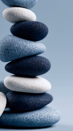 Minimalist stacked pebbles centered on a soft blue and white background in a serene, textured still life aesthetic, ultra hd wallpaper