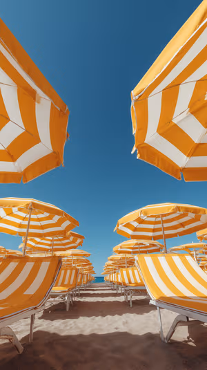 Minimalist photo of yellow and white striped beach umbrellas and loungers against a clear blue sky, ultra HD 8K background.
