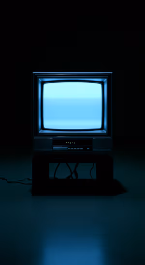 Retro television centered on a deep blue black background with cyan screen glow ultra HD image.