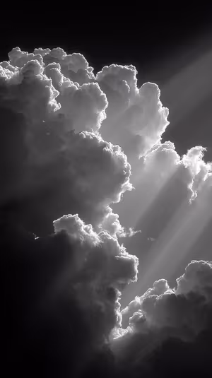Cinematic monochrome cloudscape with sunbeams piercing a dark sky ultra HD 8K lock screen background.
