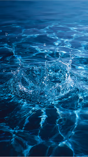 Photoreal water splash centered on a deep blue teal surface in a crisp photoreal aesthetic, ultra hd wallpaper.