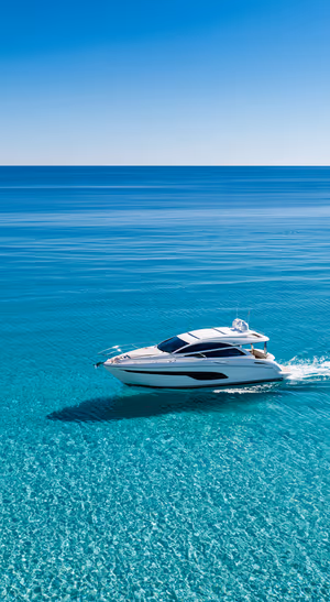Minimalist white yacht on a blue ocean background in a clean aesthetic.