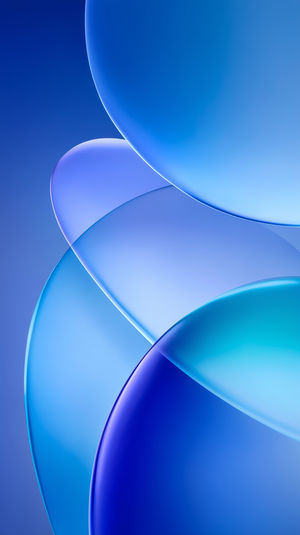 Overlapping translucent blue spheres on a gradient background, creating an abstract 3D bubble effect wallpaper.