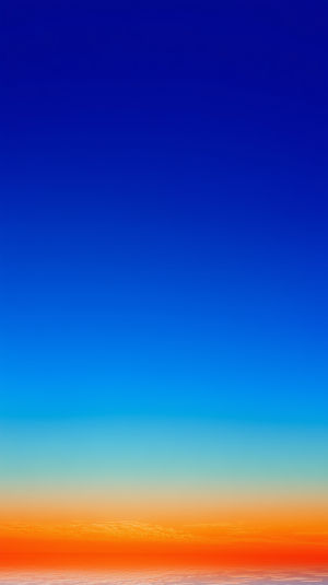 A vivid 4K sunset gradient transitioning from deep blue sky to fiery orange horizon, minimalist backdrop.