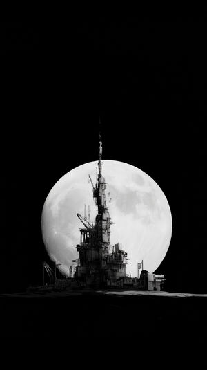 Silhouette of a futuristic industrial tower on a barren landscape with a giant full moon glowing behind in a dark sky.