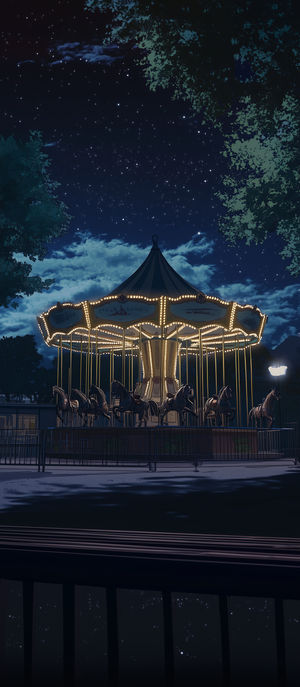 A softly lit vintage carousel illuminated under a starry night sky framed by trees in a serene park at nighttime.