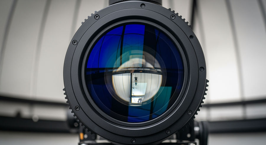 Close-up of telescope lens showing intricate details and reflections