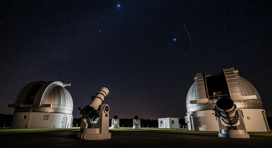 Swinburne University observatory at night with telescopes under stars