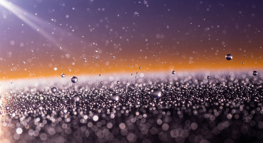 Close-up of helium particles in exoplanet atmosphere with light interaction