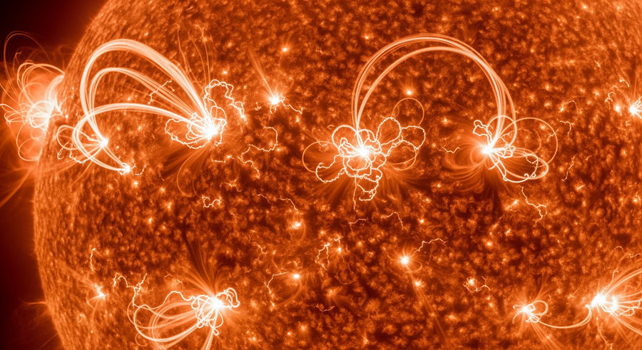 close-up of twin star surface showing solar flares and plasma arcs