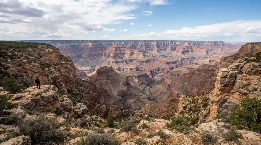 Vast Grand Canyon landscape with river, cliffs, and sky