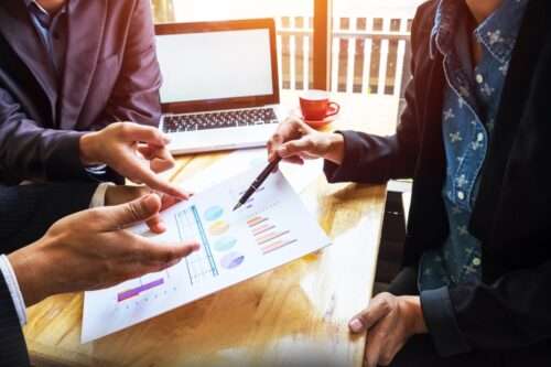 business team working on a new business plan with modern digital computer