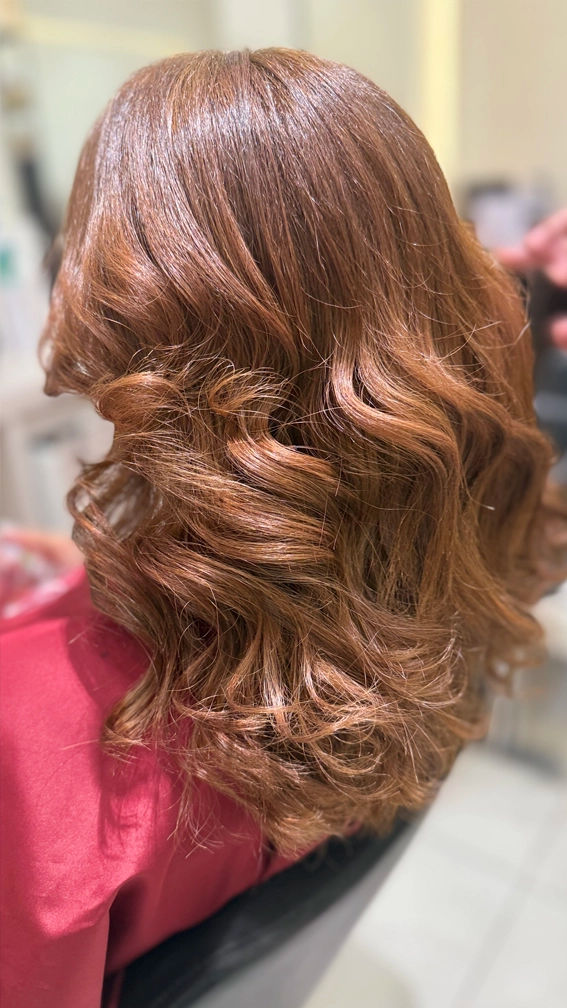 Woman with reddish-brown wavy hair