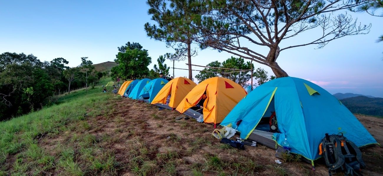 Group of 5 person tents on mountain ridge