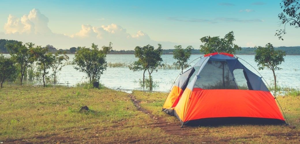 3 person tent camped by lake