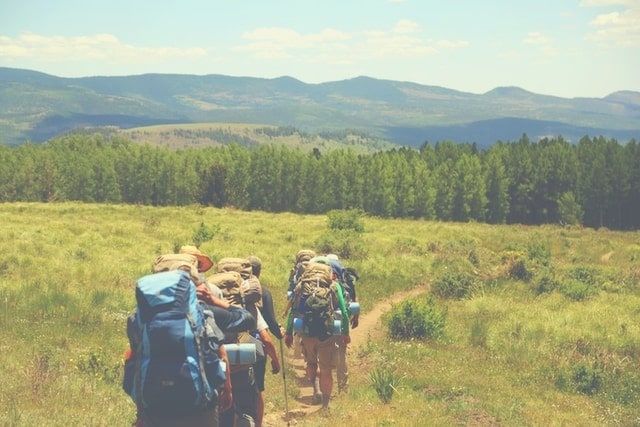 Group of backpackers exercising