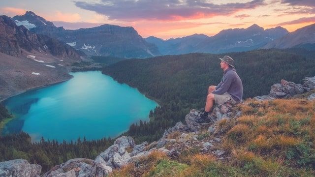 Relaxed hiker on mountain top