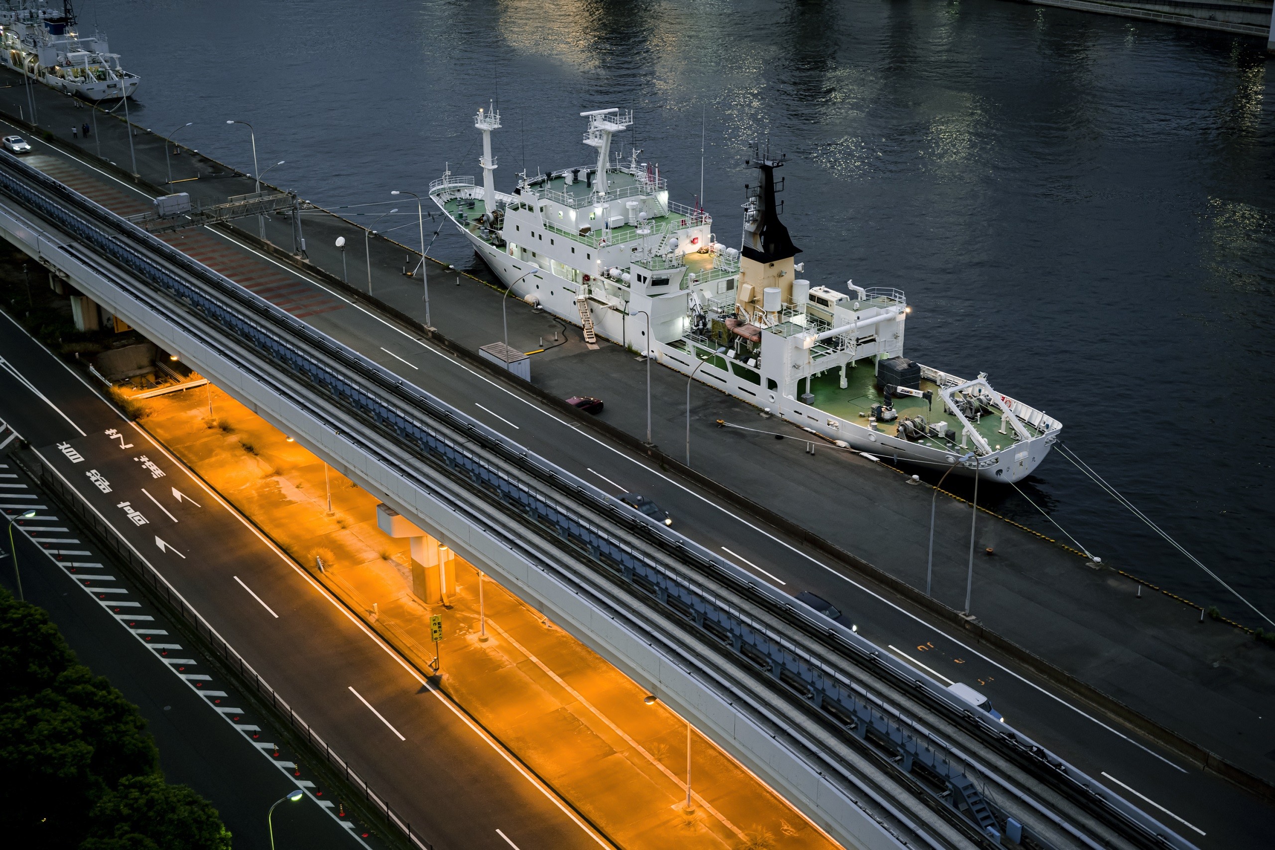 White ship docked beside elevated road, photographed with the Sigma fp camera White ship docked beside elevated road, photographed with the Sigma fp camera