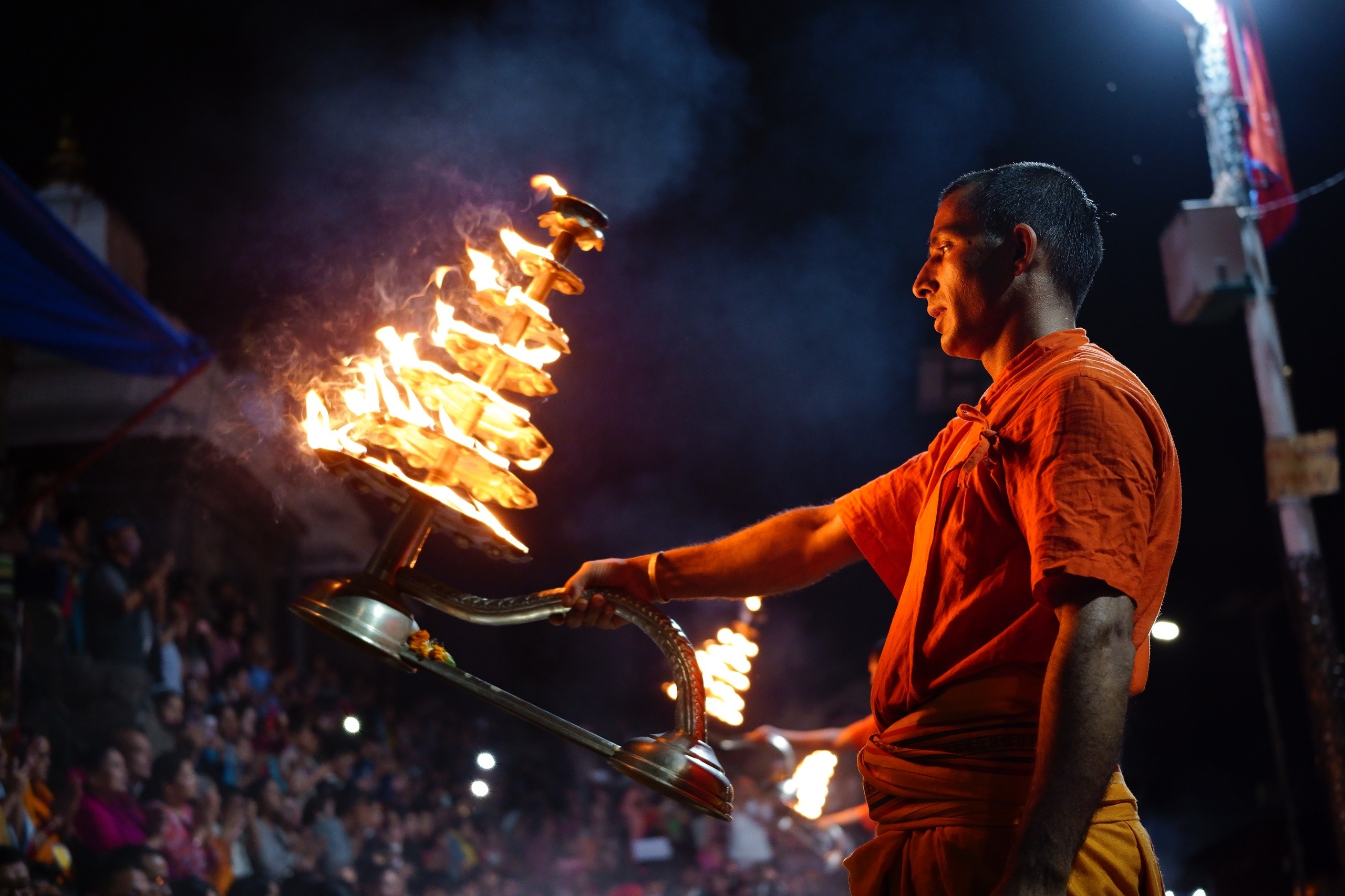 Monk waving ornate torch with crowd watching in background, photographed with the Sigma fp camera Monk waving ornate torch with crowd watching in background, photographed with the Sigma fp camera
