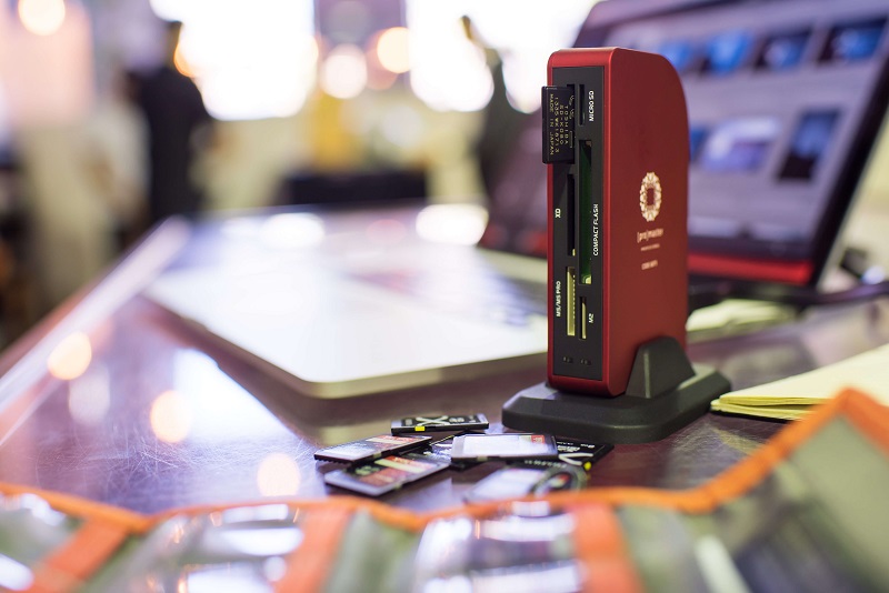 a bunch of memory cards and a red memory card reader