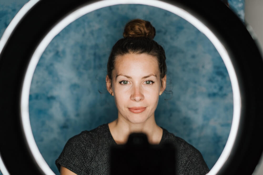 Female vlogger using a ring light setup