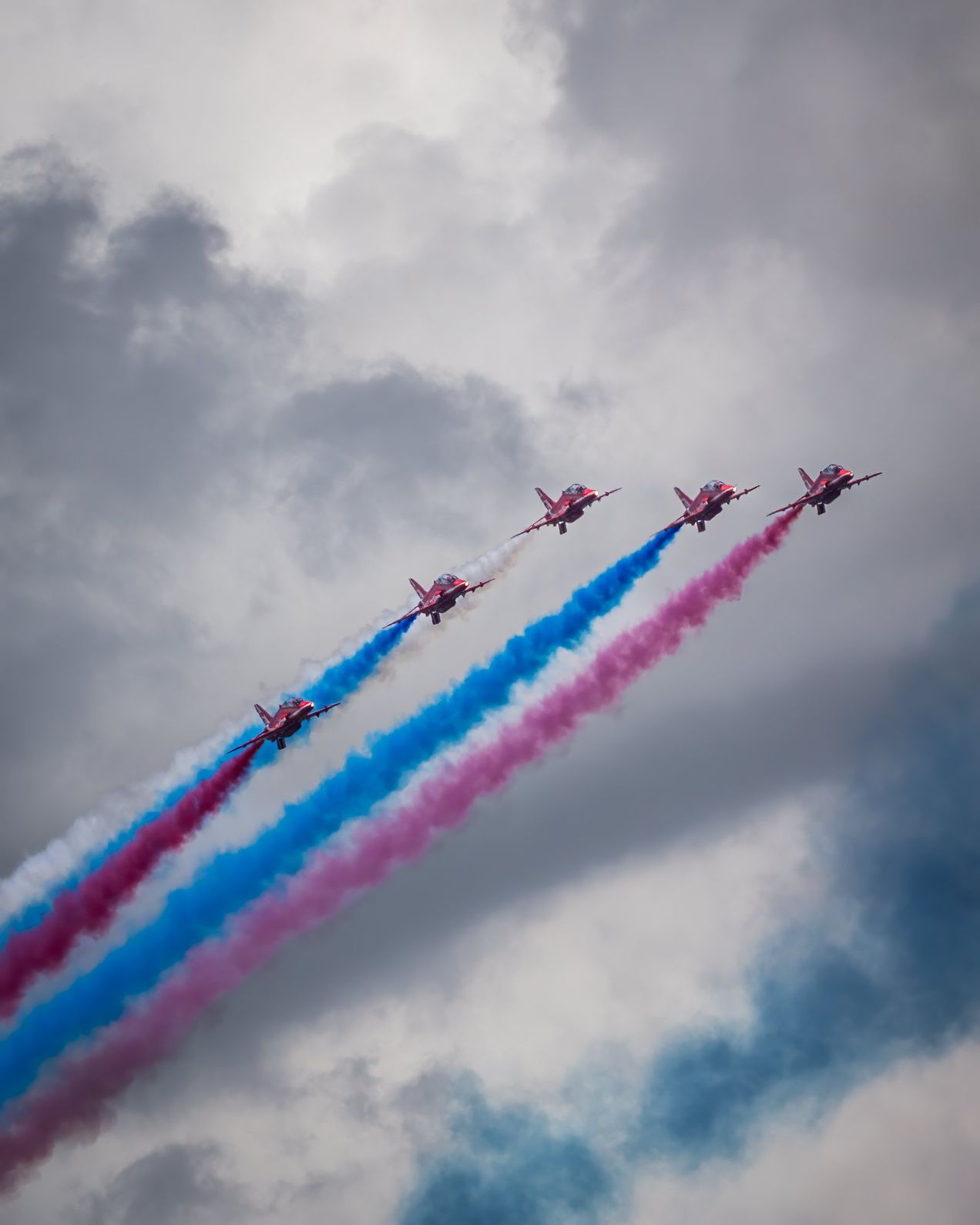 Planes fly overhead releasing red, white and blue smoke over Silverstone circuit