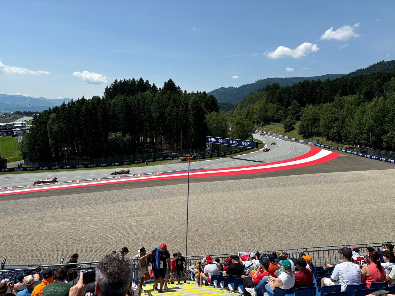 F1 cars coming out of turn 9 of the Red Bull Ring during the Austrian GP