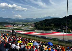 Fans on Grandstand T3 on the Red Bull Ring watching the drivers take on corner 3