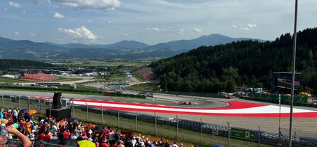 Fans on Grandstand T3 on the Red Bull Ring watching the drivers take on corner 3