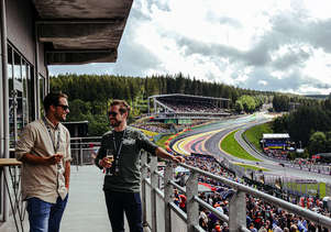 Guests enjoying a glass of Champagne on the balcony of the Gold 2 VIP Lounge
